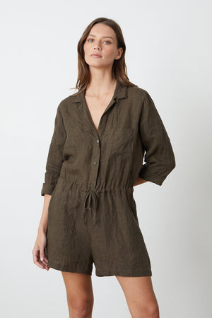 a woman wearing a green RUTH LINEN ROMPER by Velvet by Graham & Spencer.