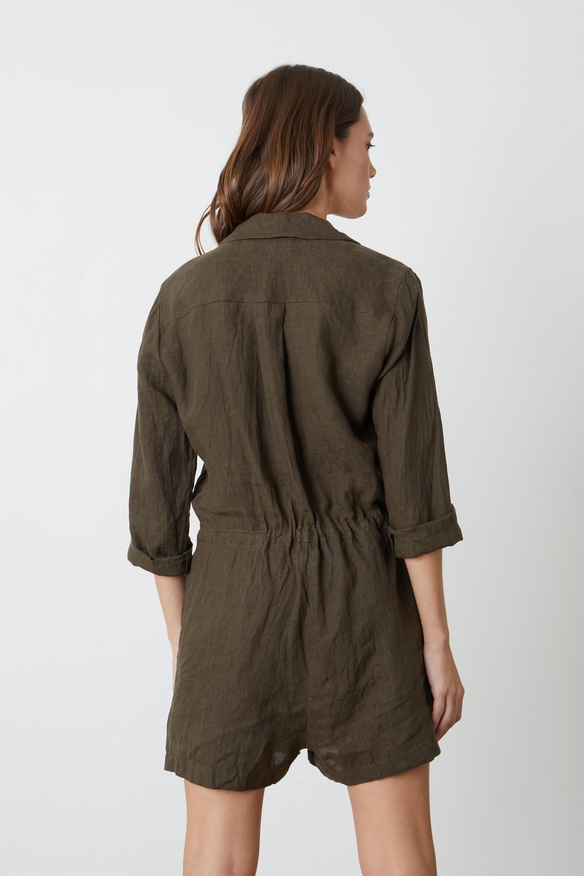 the back view of a woman wearing an olive Velvet by Graham & Spencer RUTH LINEN ROMPER.-26327261380801