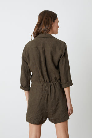the back view of a woman wearing an olive Velvet by Graham & Spencer RUTH LINEN ROMPER.