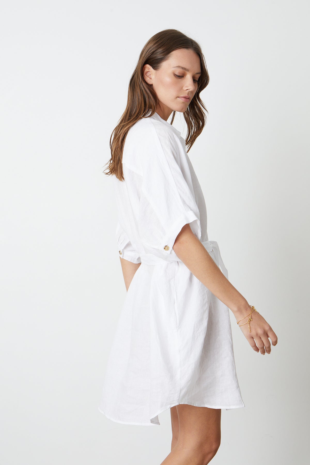   The model is wearing the STEVIE LINEN BUTTON-UP DRESS by Velvet by Graham & Spencer. 