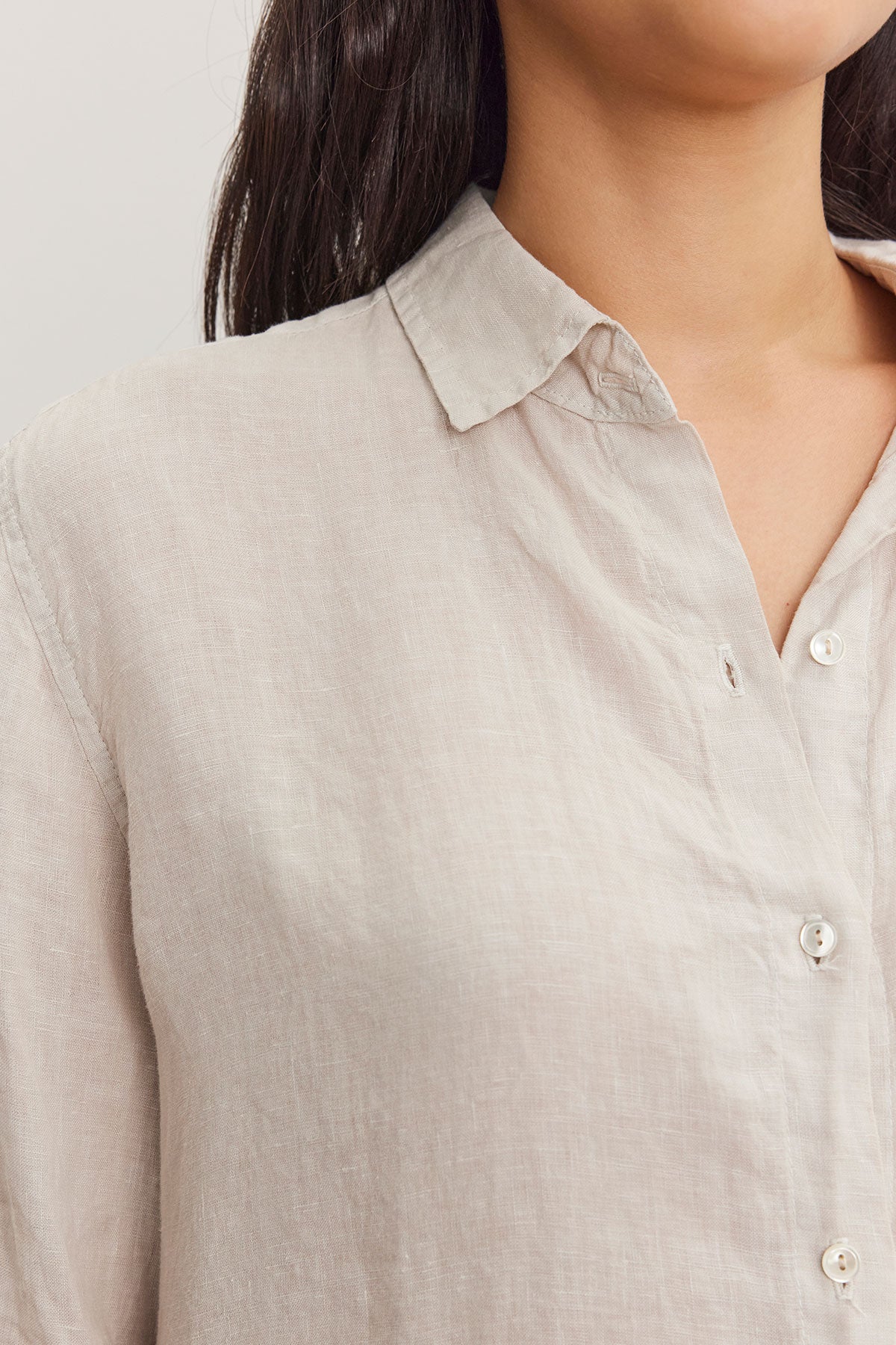 Close-up of a woman wearing a Velvet by Graham & Spencer WILLOW LINEN BUTTON-UP SHIRT with visible buttons and collar details.-36998739165377