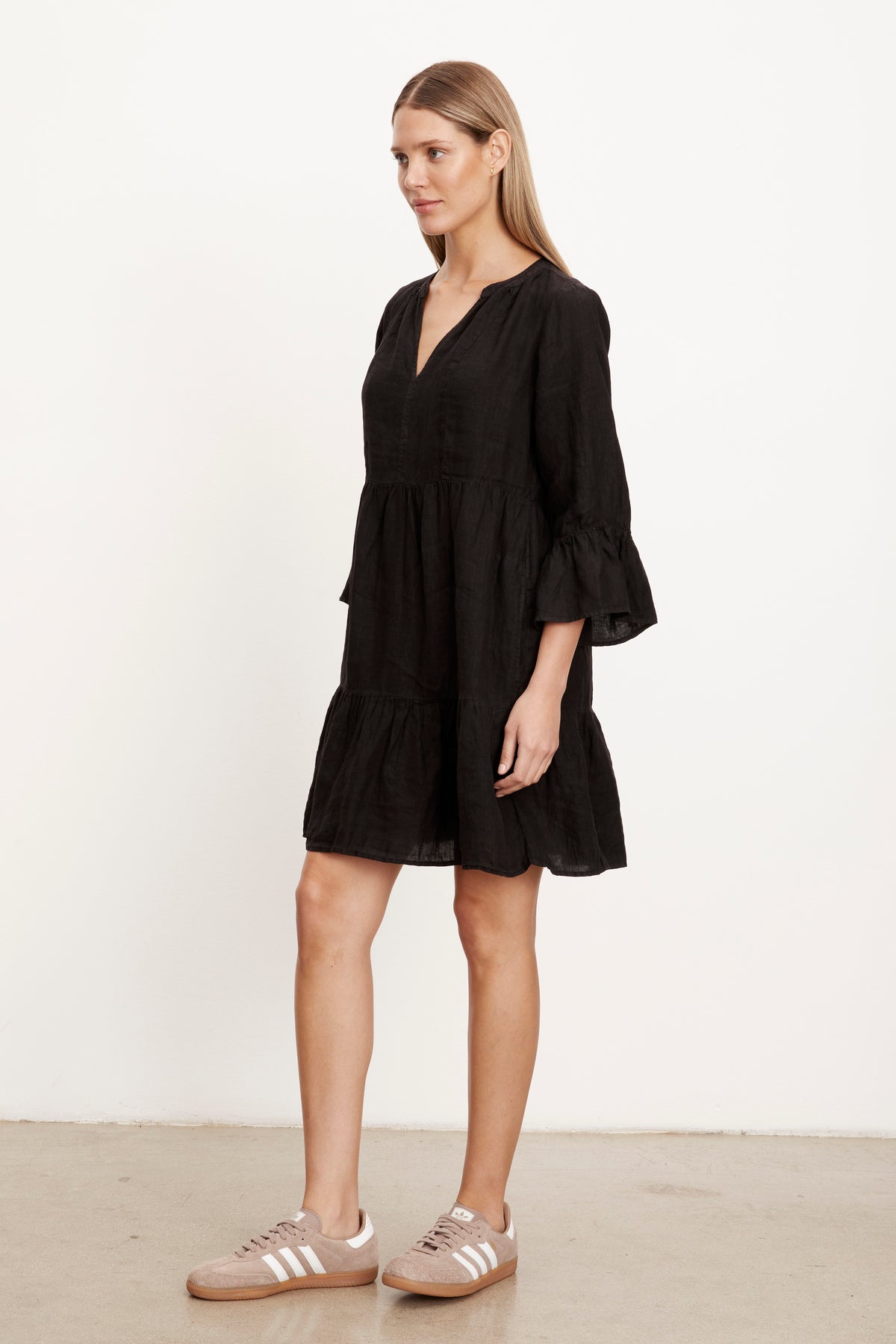   Full length 3/4 view of woman wearing Aurora Tiered Dress in black linen 