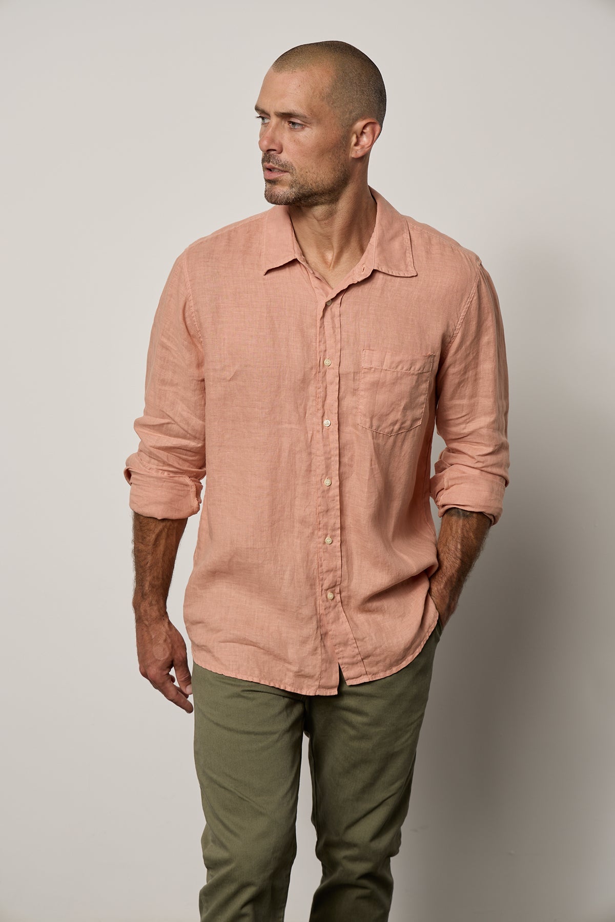   Benton Button-Up Shirt in bronze linen sleeves rolled front, model hand in pant pocket 