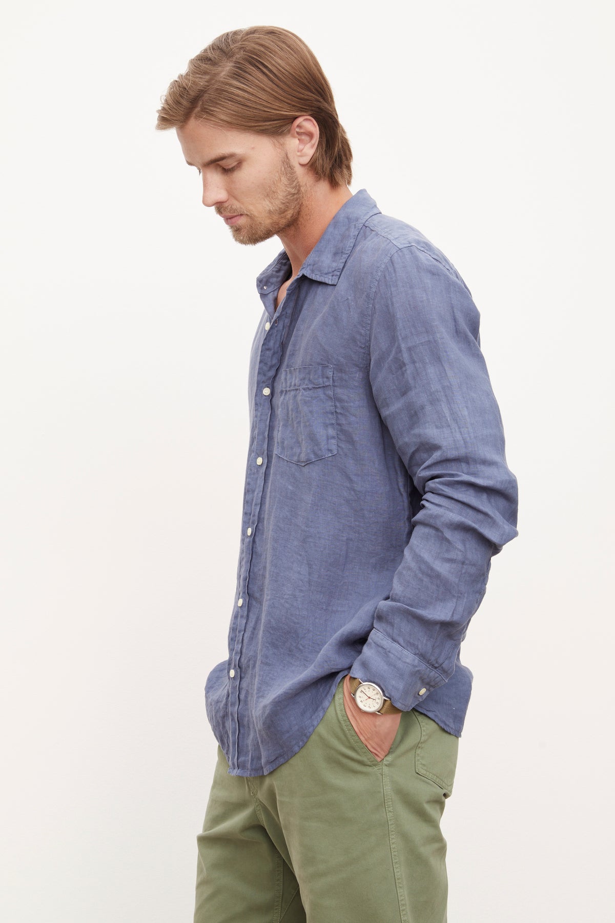 A man wearing a stylish Velvet by Graham & Spencer BENTON LINEN BUTTON-UP SHIRT and green pants.-36009360621761