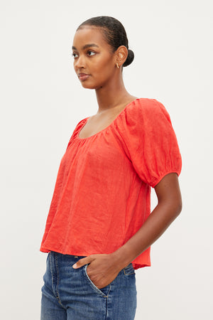 The model is wearing a Dana Linen Scoop Neck Top by Velvet by Graham & Spencer with puff sleeves.