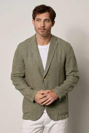 A man wearing a Velvet by Graham & Spencer JOSHUA LINEN BLAZER adorned in a green linen jacket.