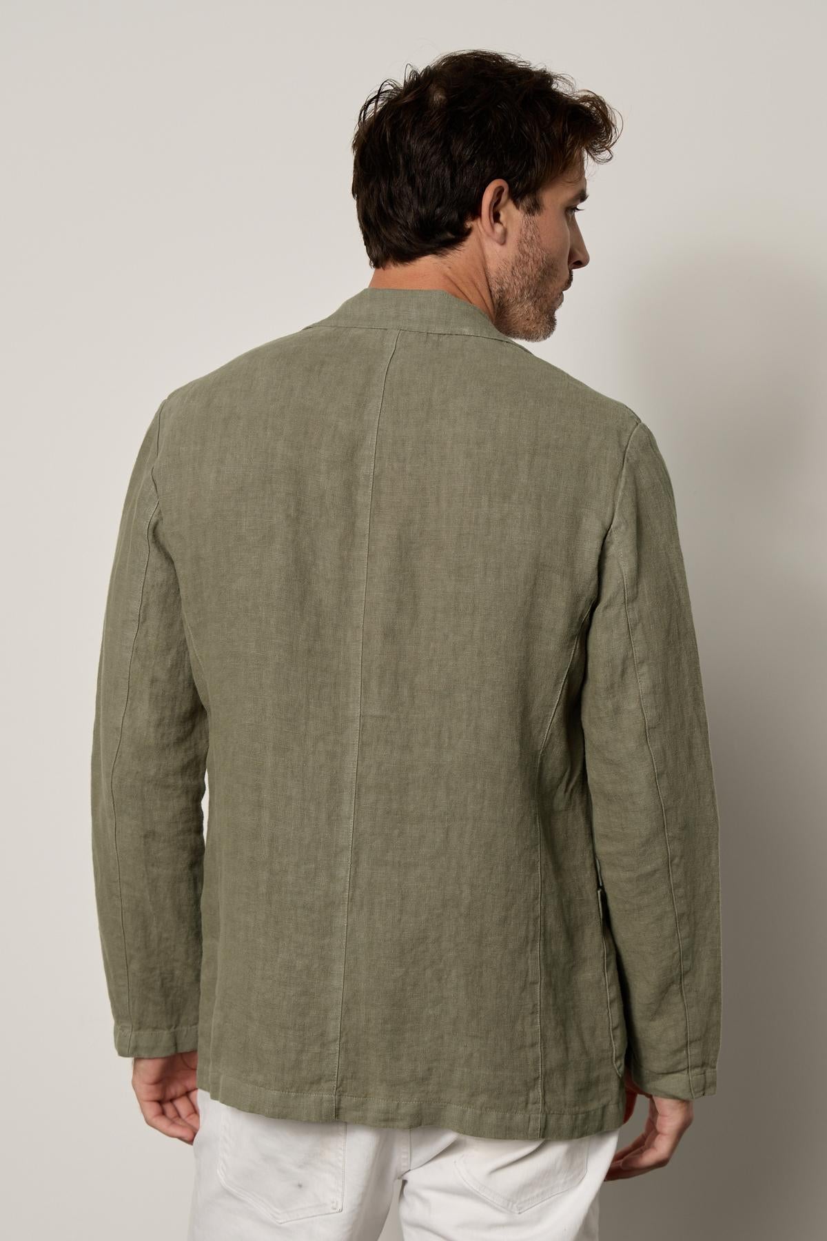   The back view of a man wearing a Velvet by Graham & Spencer Joshua Linen Blazer. 