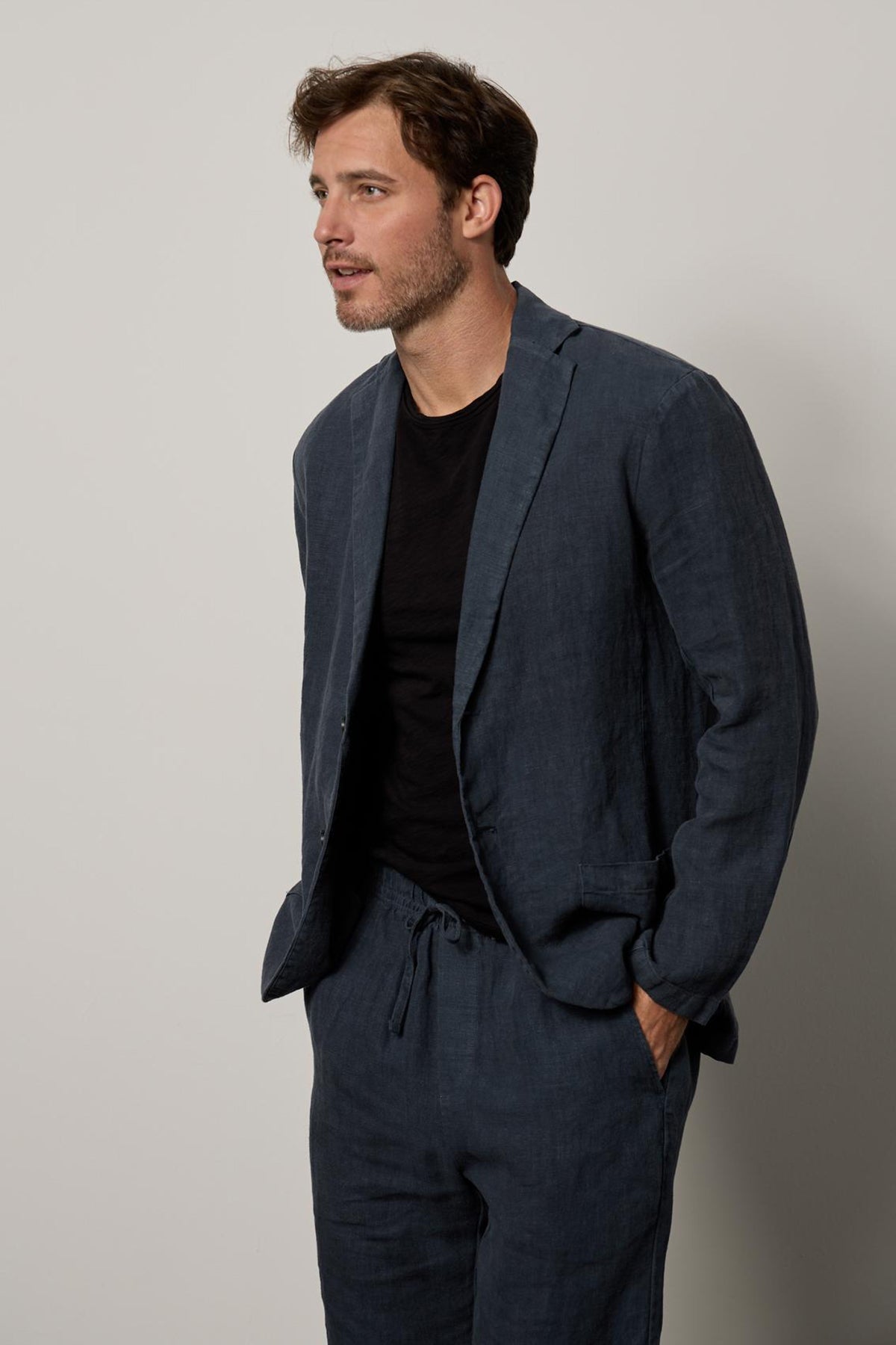 A man wearing a Joshua Linen Blazer by Velvet by Graham & Spencer and a black t-shirt.-26311108755649