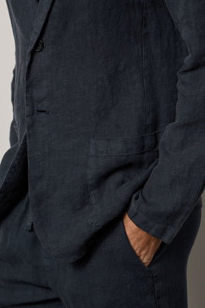 A man wearing a Velvet by Graham & Spencer JOSHUA LINEN BLAZER in medium-weight linen.