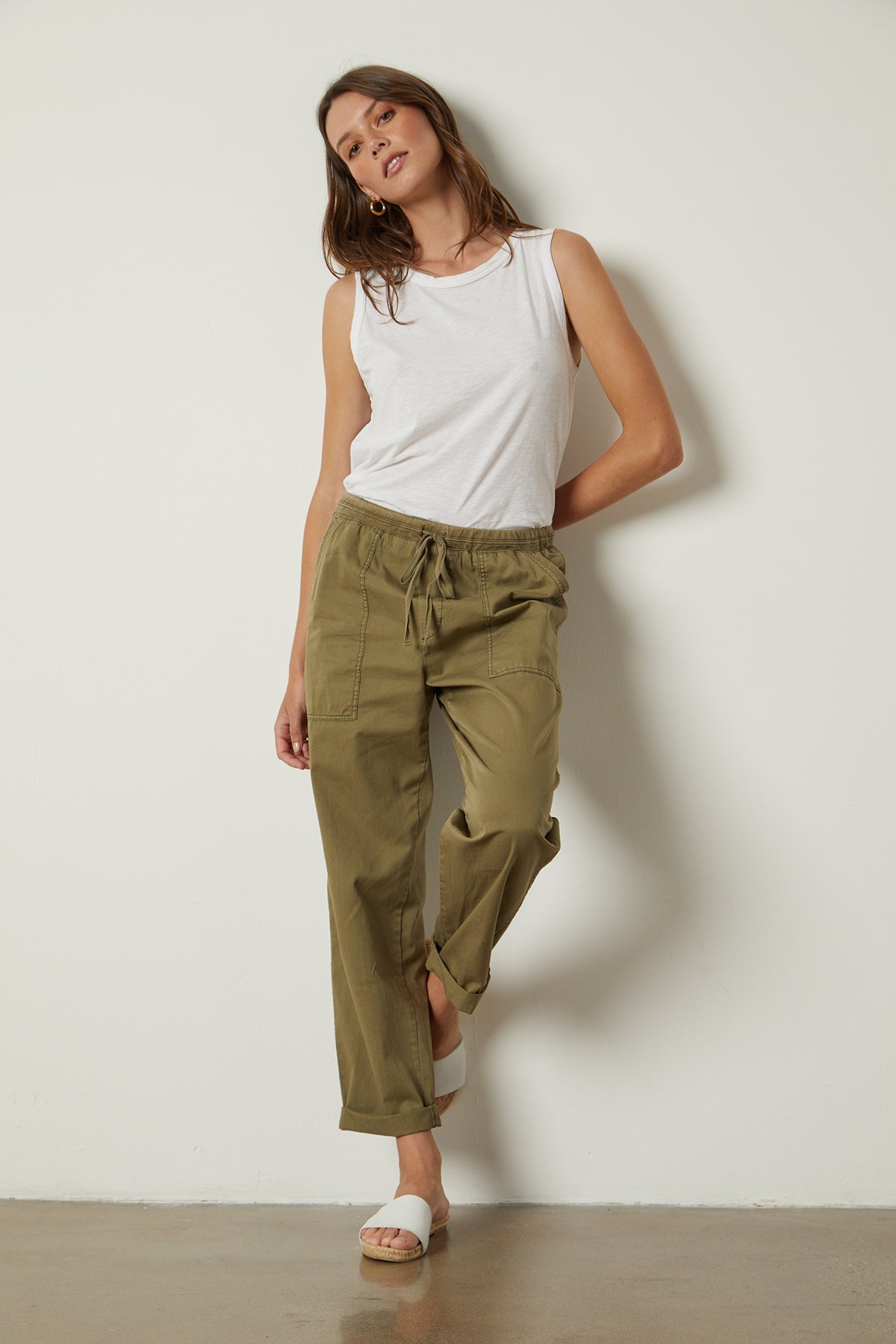   Misty Pant in forest twill with Taurus Tank tucked full length front with white slides 