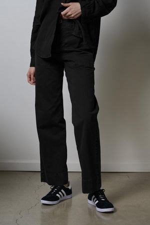 A woman wearing Velvet by Jenny Graham's VENTURA PANTS and a white shirt.