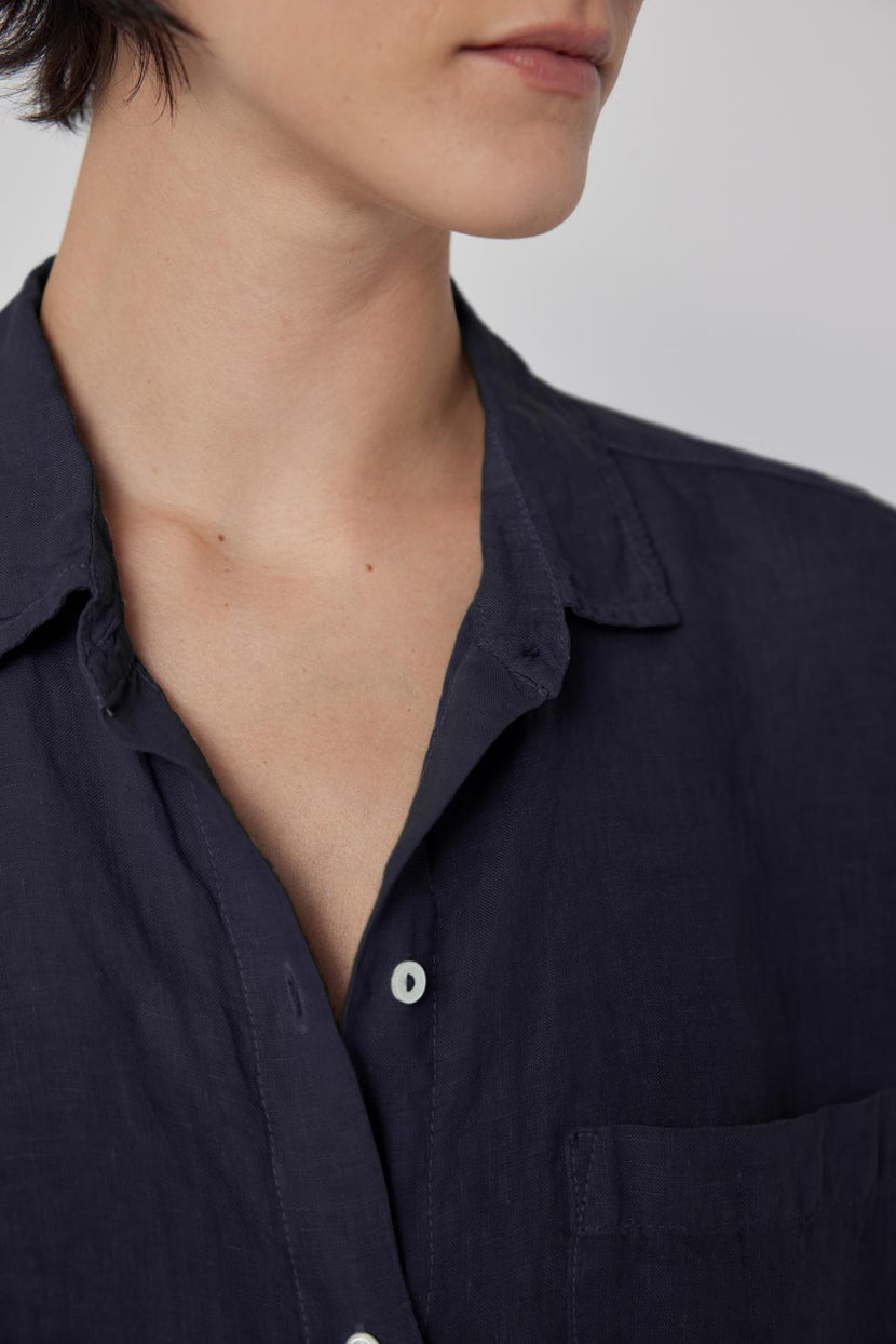 The model is wearing a Navy Linen Button-Up Shirt with a relaxed silhouette.