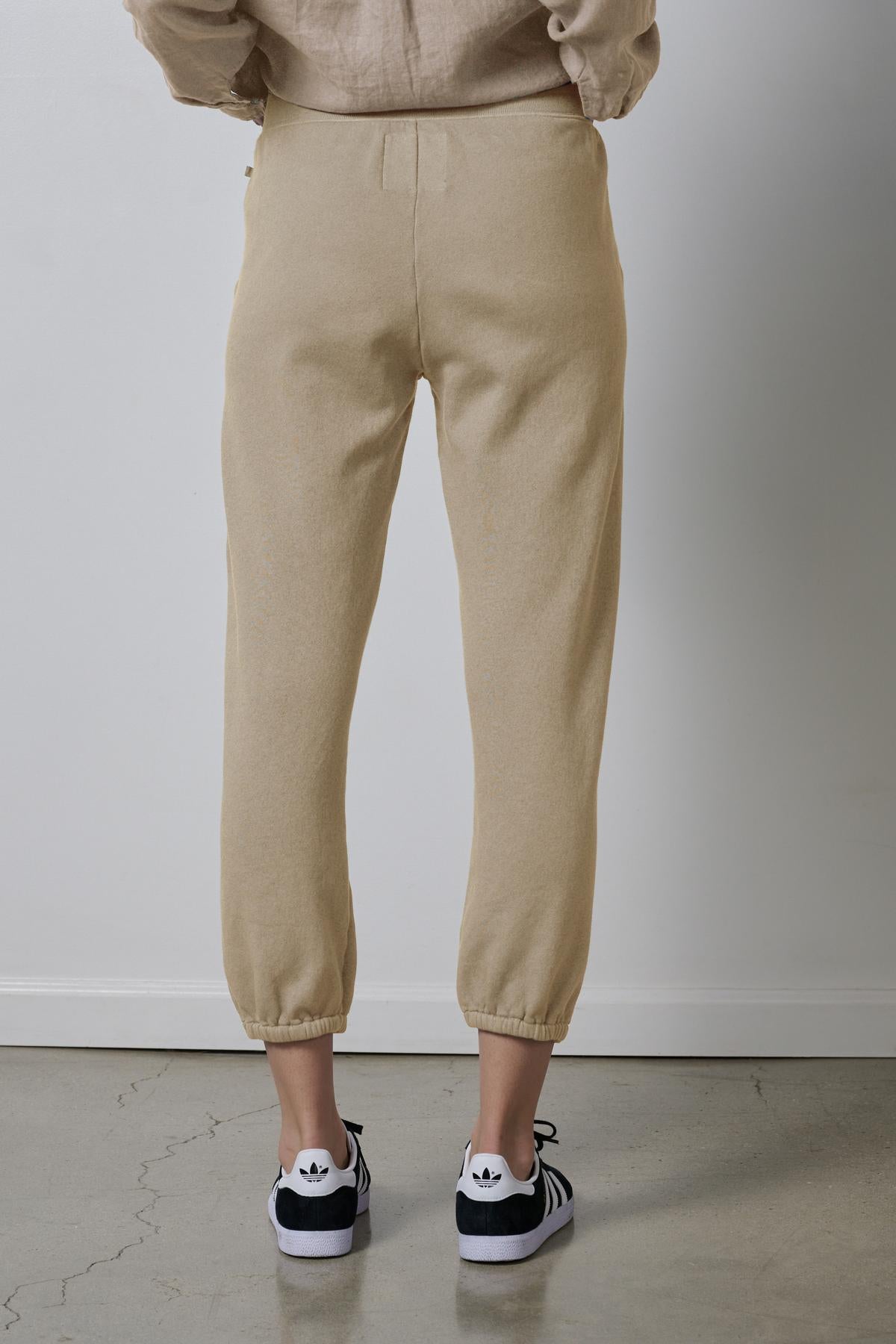 Person standing in Velvet by Jenny Graham ZUMA SWEATPANT and black-and-white sneakers.-36463615639745
