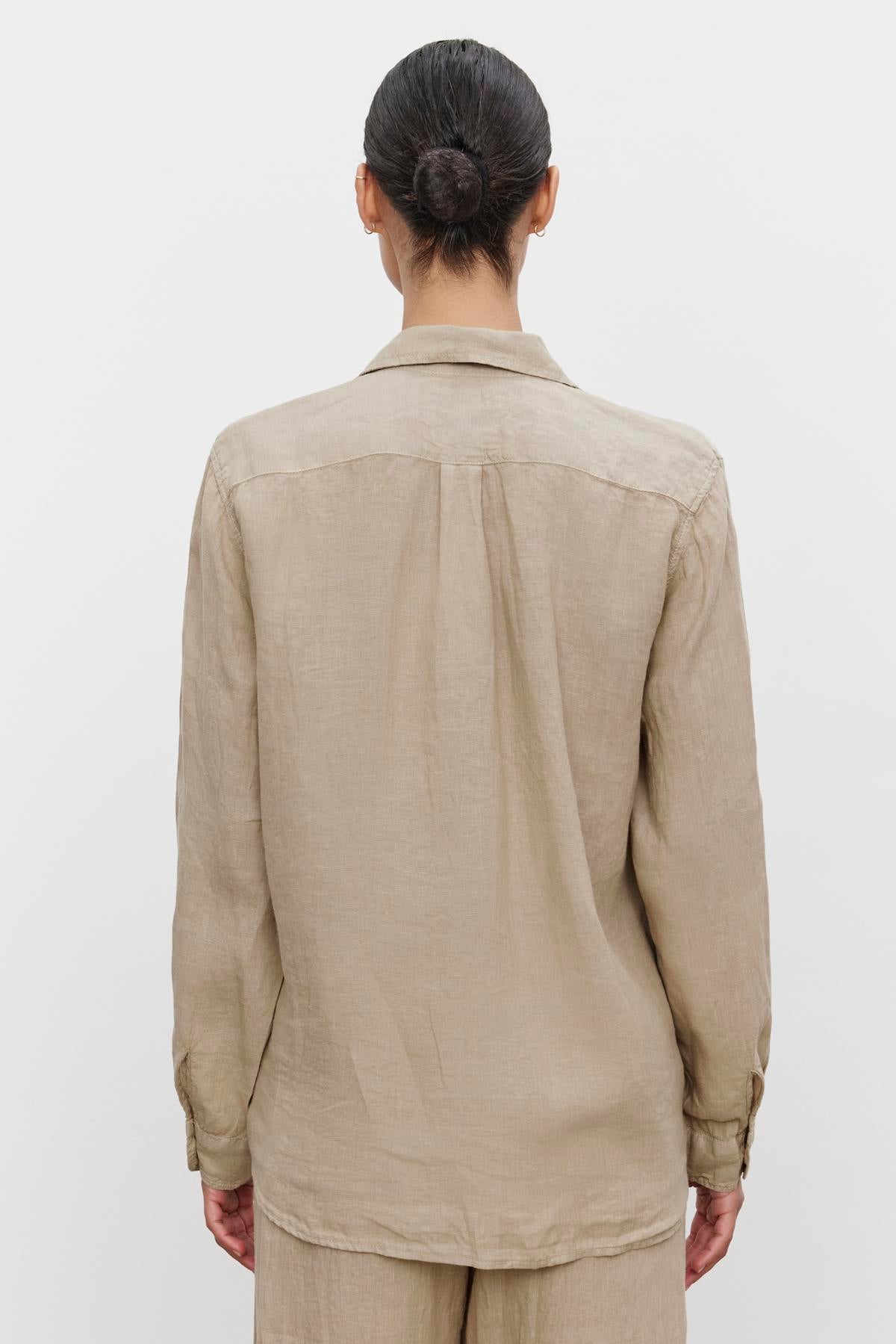   Woman in a Velvet by Jenny Graham Mulholland Shirt with a scooped hemline, viewed from the back. 