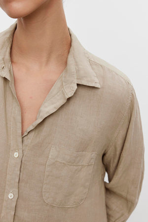 Close-up of a person wearing a Velvet by Jenny Graham Mulholland shirt with a relaxed silhouette, a collar, and chest pocket.
