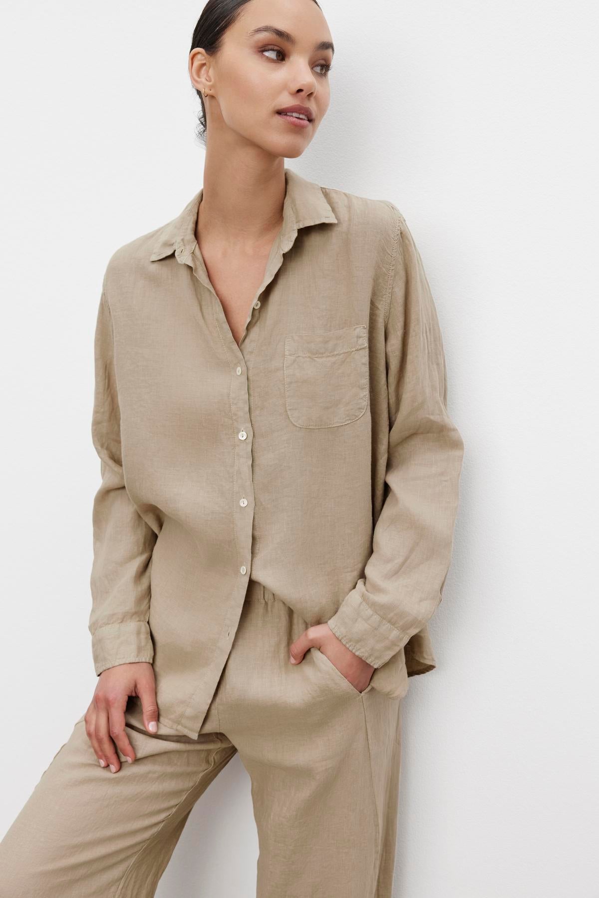 A woman wearing a relaxed silhouette, casual beige linen Mulholland shirt by Velvet by Jenny Graham with a scooped hemline and matching pants.-36463469658305