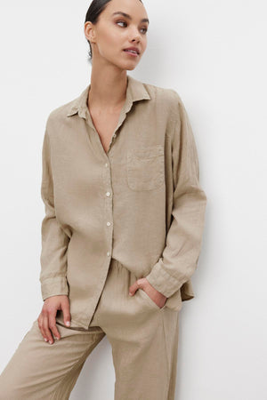 A woman wearing a relaxed silhouette, casual beige linen Mulholland shirt by Velvet by Jenny Graham with a scooped hemline and matching pants.