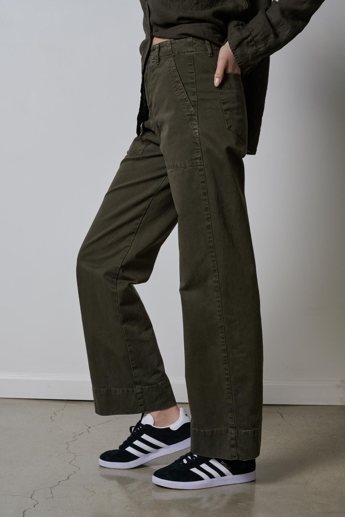 A woman wearing a pair of Velvet by Jenny Graham VENTURA PANTS and sneakers.-26827818631361
