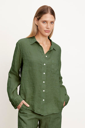 A woman wearing a Natalia Linen Button-Up Shirt and pants, perfect for the warmer months, by Velvet by Graham & Spencer.