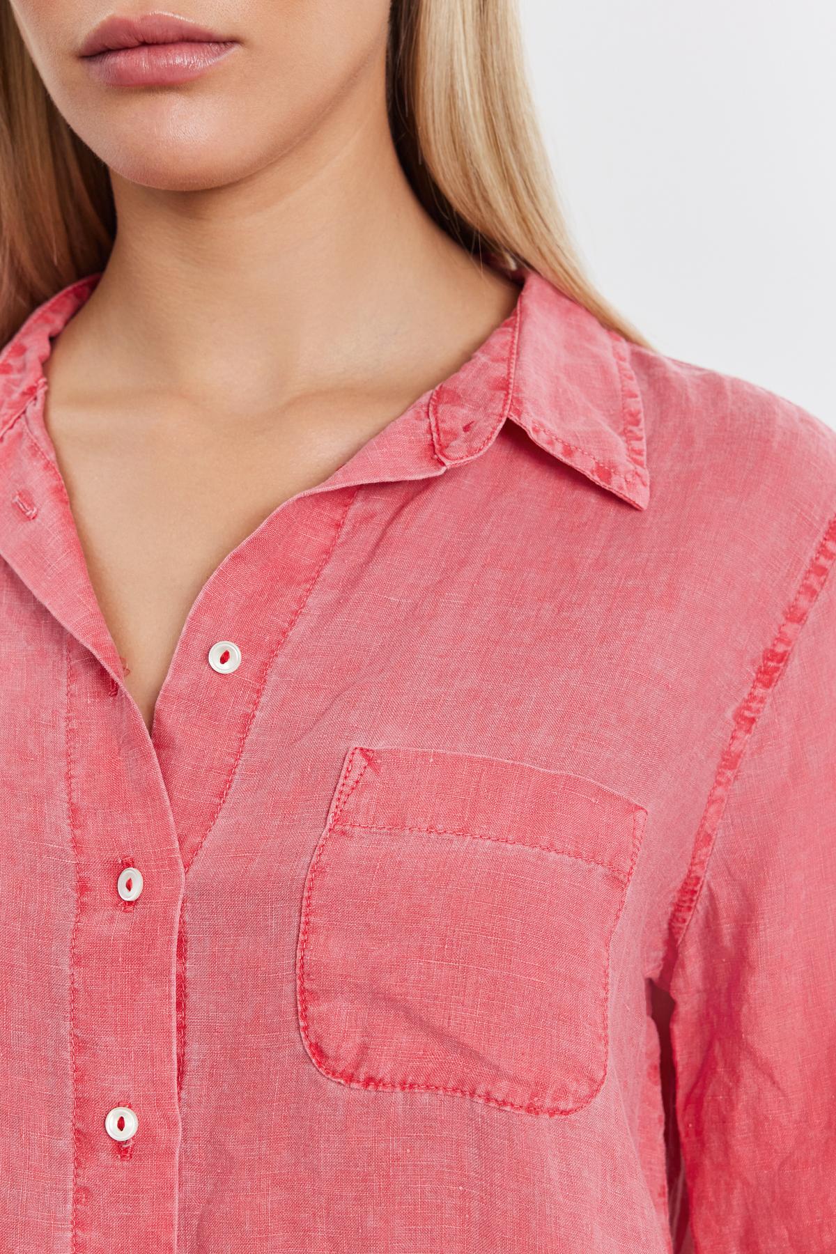 Close-up of a woman wearing a NATALIA LINEN BUTTON-UP SHIRT in coral pink from Velvet by Graham & Spencer with a relaxed silhouette, collar, buttons, and a front pocket.-36910075838657