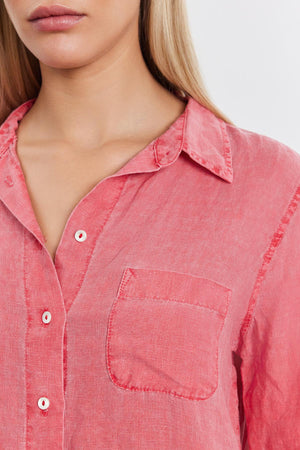 Close-up of a woman wearing a NATALIA LINEN BUTTON-UP SHIRT in coral pink from Velvet by Graham & Spencer with a relaxed silhouette, collar, buttons, and a front pocket.