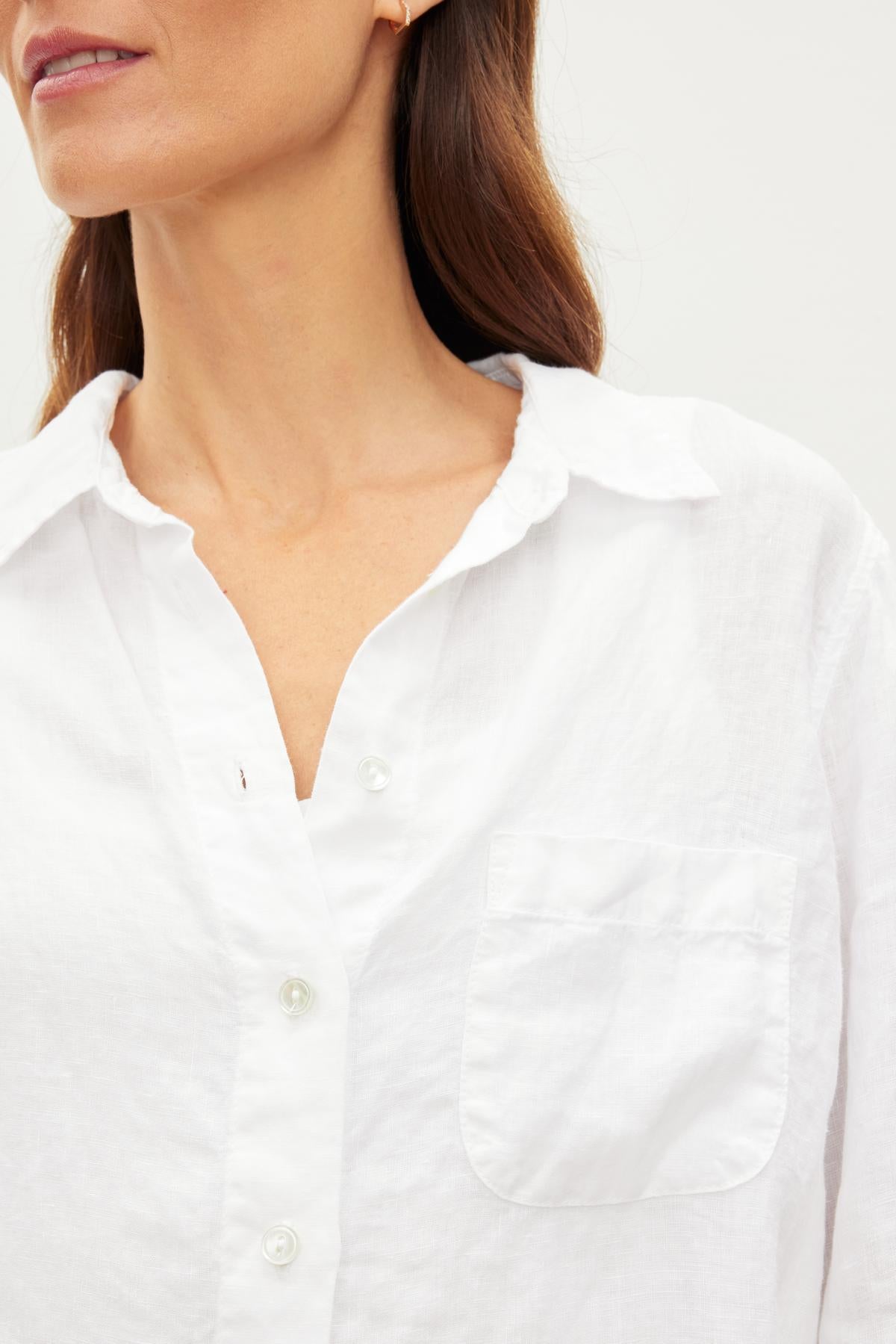 A woman wearing a NATALIA LINEN BUTTON-UP SHIRT by Velvet by Graham & Spencer, perfect for the warmer months.-36010138665153