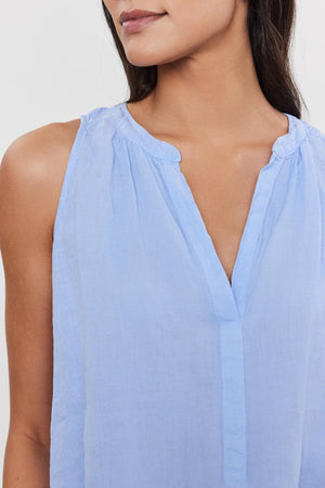 Close-up of a woman wearing a Velvet by Graham & Spencer TACY LINEN TANK TOP with a v-neckline.