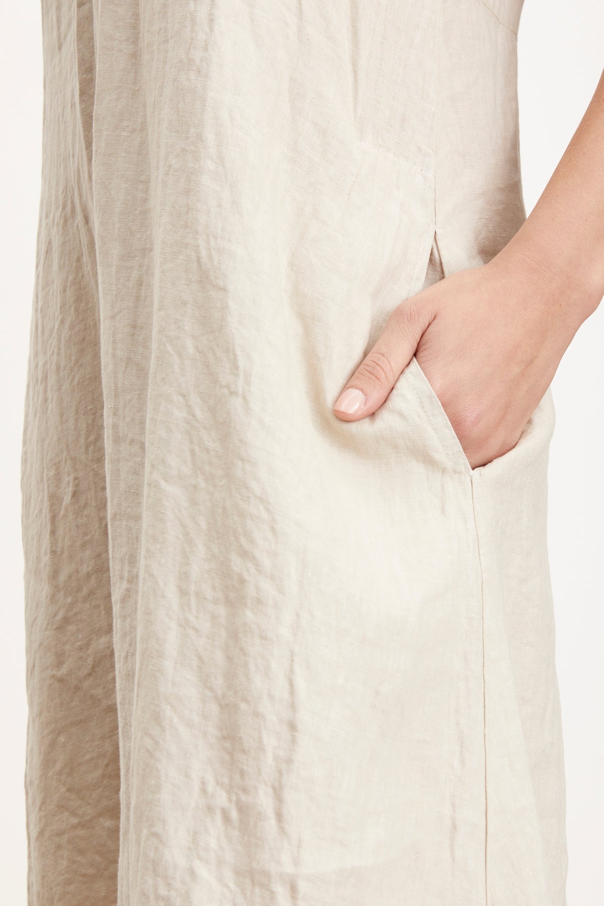   Detail of Winley Dress in sand colored linen with woman's hand in pocket 