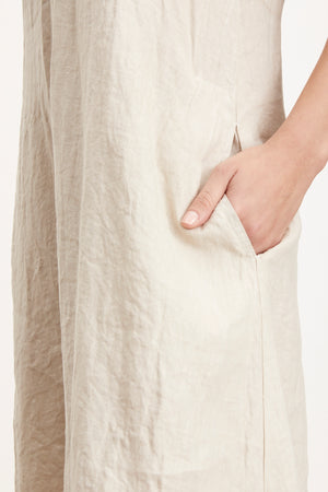 Detail of Winley Dress in sand colored linen with woman's hand in pocket