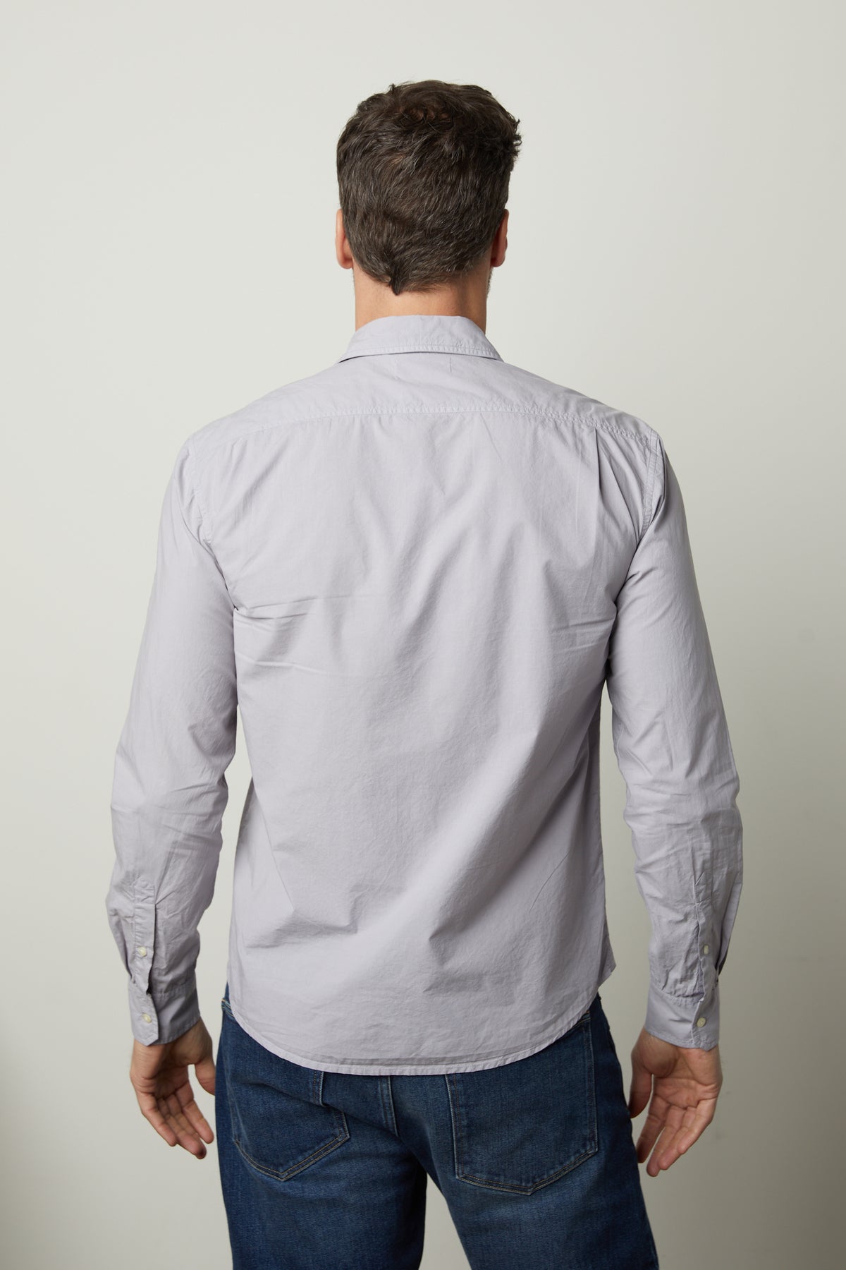 The back view of a man wearing jeans and a Velvet by Graham & Spencer BROOKS BUTTON-UP SHIRT.-35782370066625