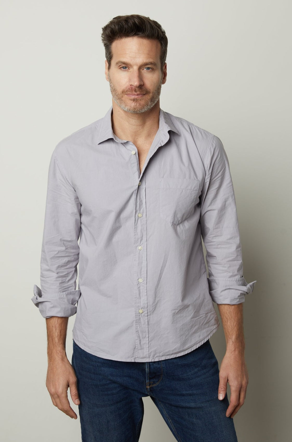 A man wearing jeans and a Velvet by Graham & Spencer BROOKS BUTTON-UP SHIRT.-35782369968321
