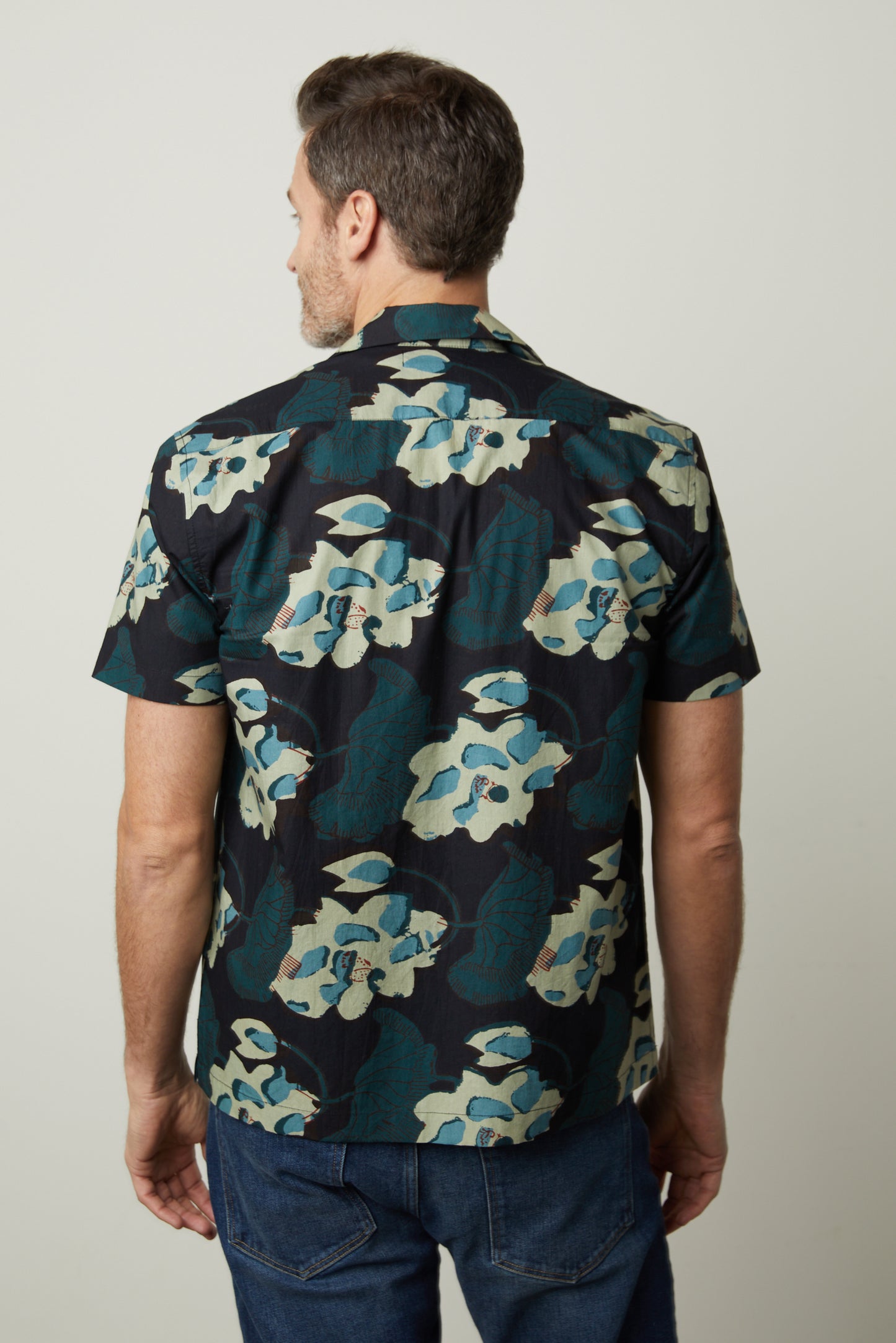 The back view of a man wearing a Velvet by Graham & Spencer IGGY PRINTED BUTTON-UP SHIRT.-26679205003457