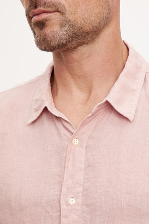 Close-up of a man wearing a Velvet by Graham & Spencer MACKIE LINEN BUTTON-UP SHIRT with focus on the collar and top buttons.