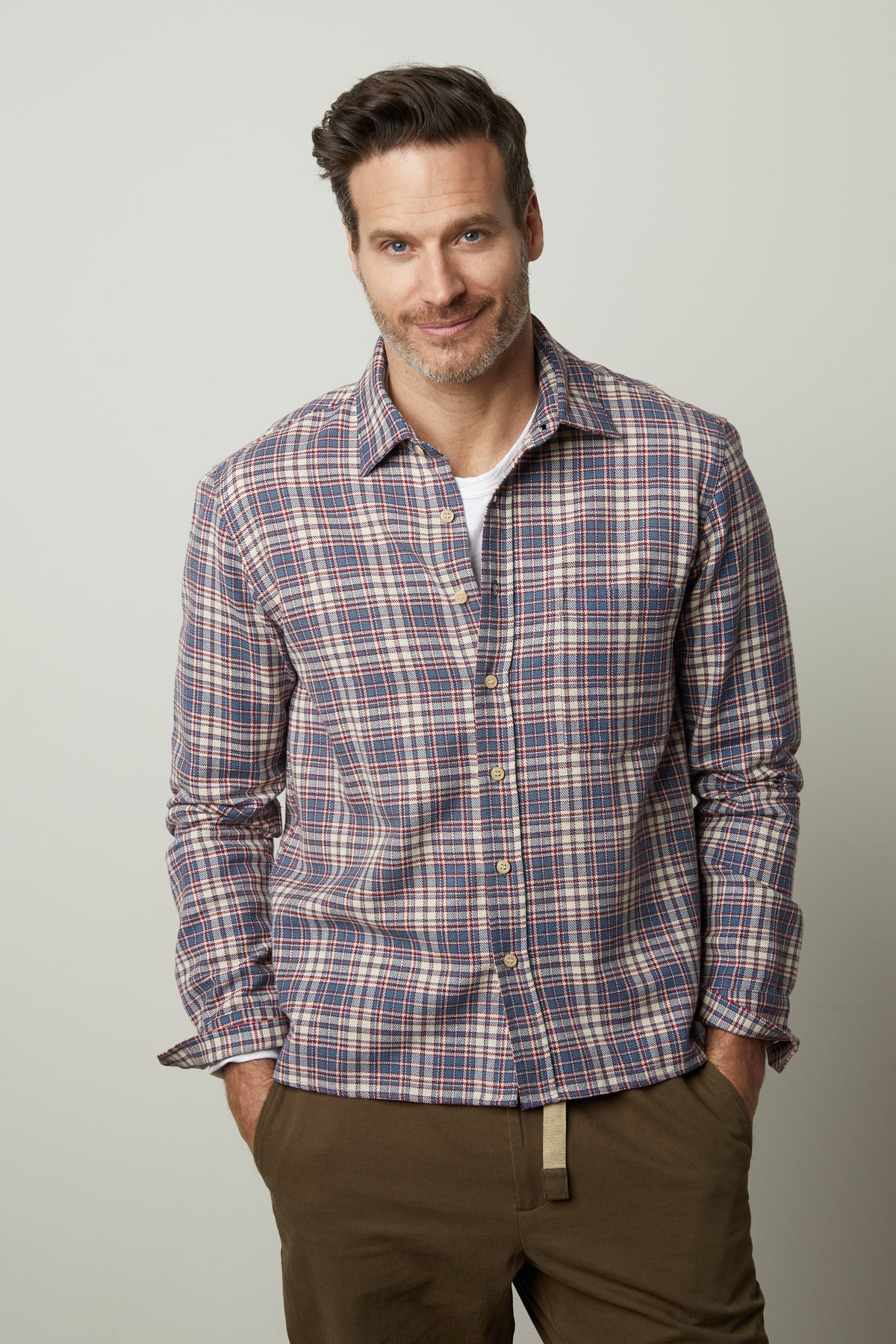  A man wearing a Velvet by Graham & Spencer STAN PLAID BUTTON-UP SHIRT and khaki pants. 
