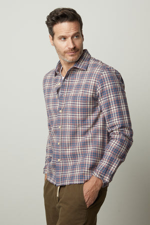 A man wearing a Velvet by Graham & Spencer STAN PLAID BUTTON-UP SHIRT and khaki pants.