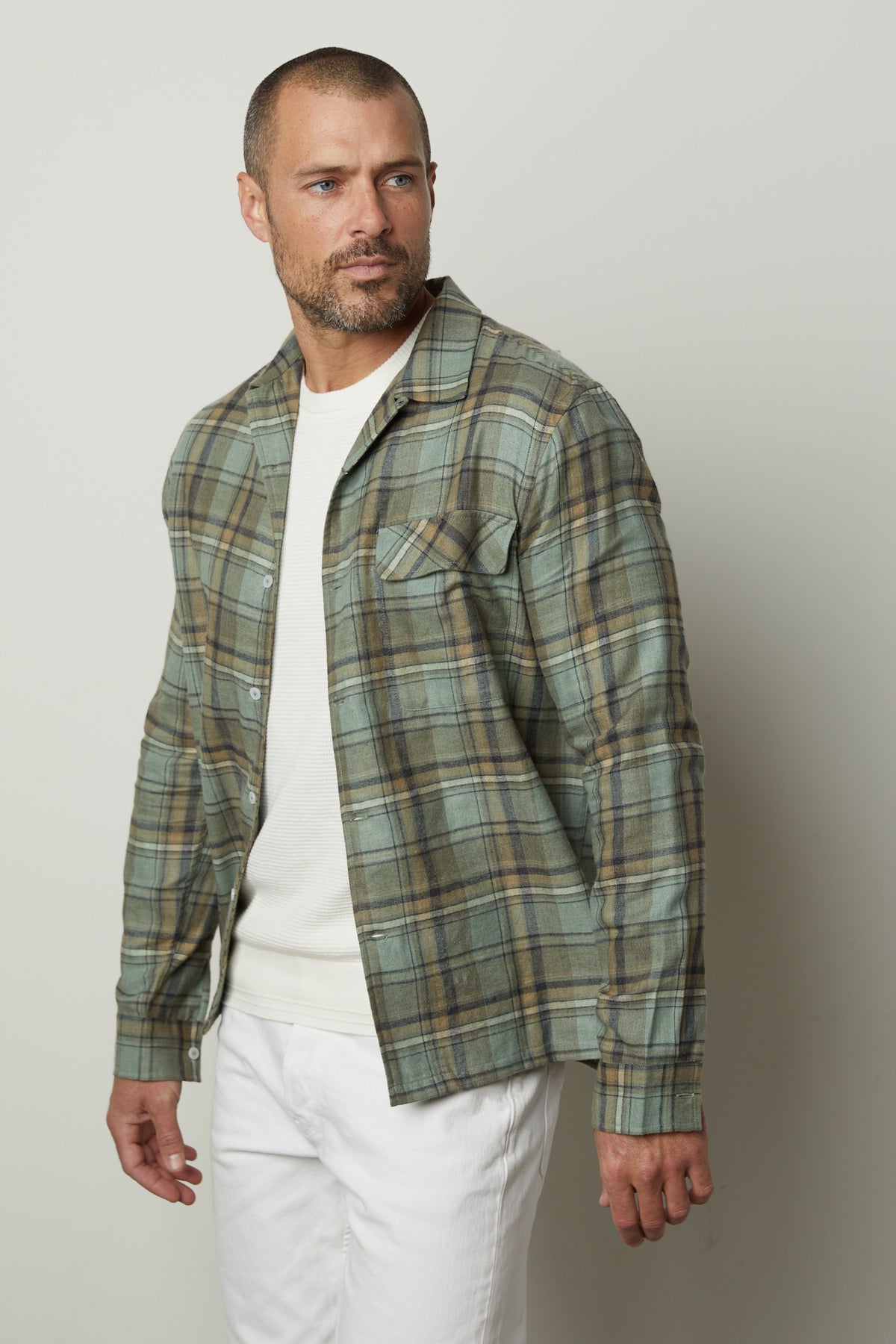 A man wearing a Timothy plaid button-up shirt by Velvet by Graham & Spencer and white pants.-26768086008001