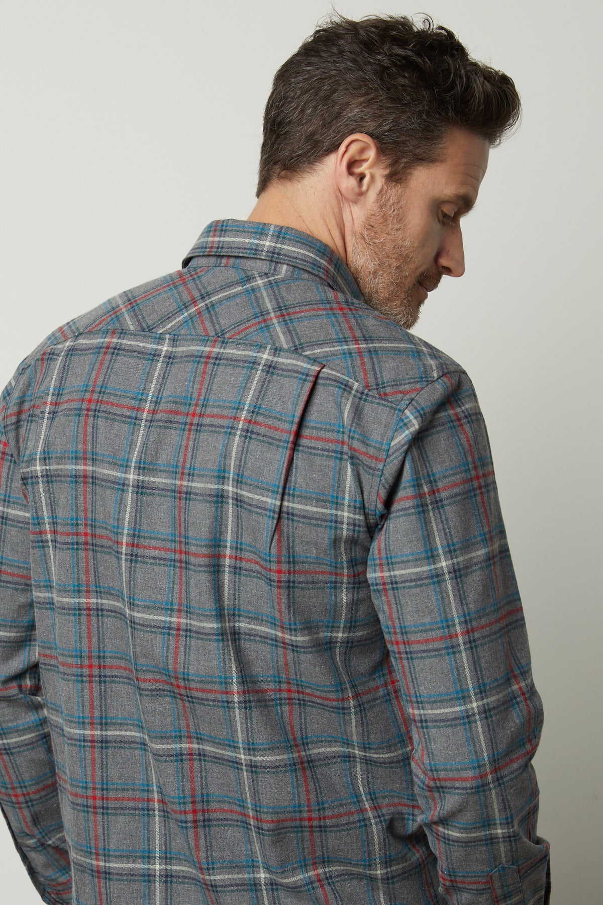 The back view of a man wearing a Velvet by Graham & Spencer Wilder Plaid Button-Up Shirt made of breathable, cotton woven fabric.-35472160817345