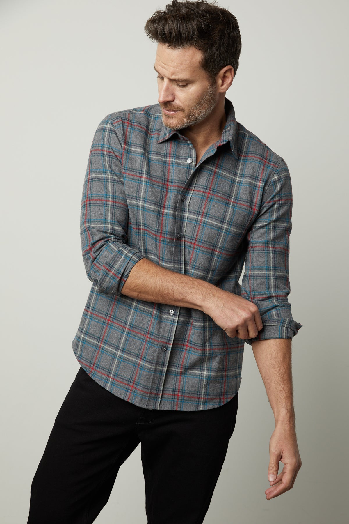   A man wearing a lightweight and breathable Velvet by Graham & Spencer Wilder Plaid Button-Up Shirt made of cotton woven fabric. 