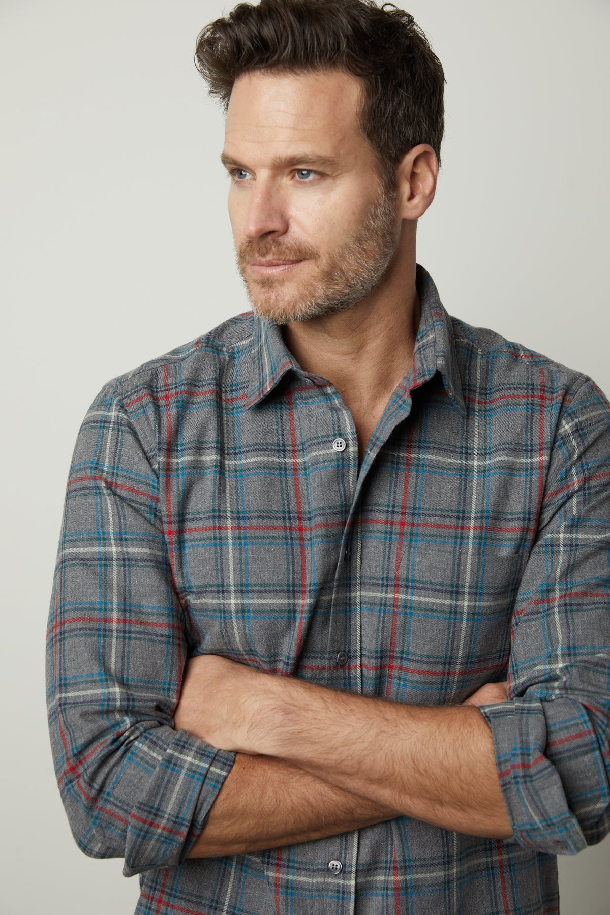 A man in a Velvet by Graham & Spencer WILDER PLAID BUTTON-UP SHIRT with his arms crossed.-35472160784577