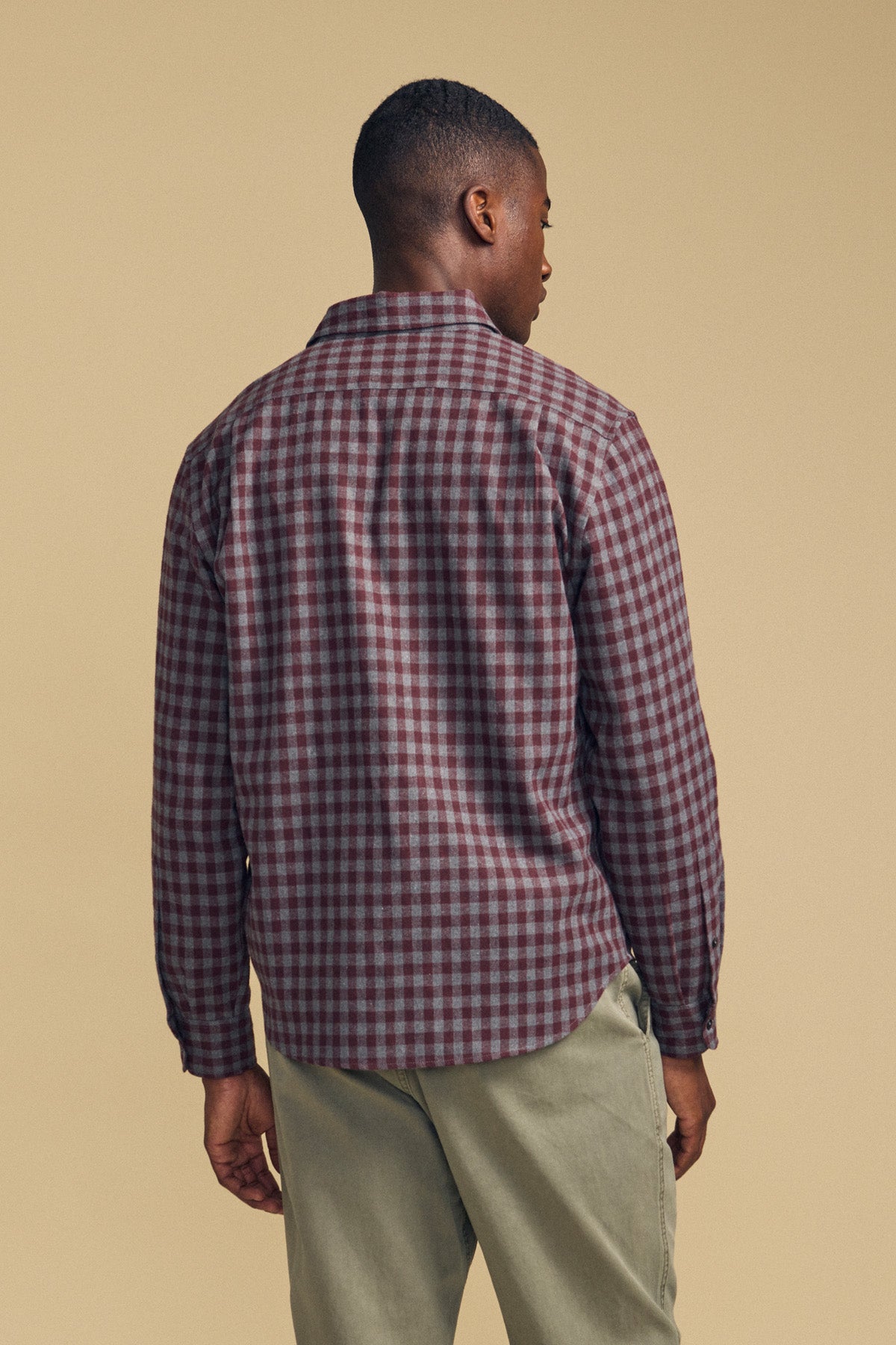 Back view of a person wearing a maroon and grey plaid DANNY PLAID BUTTON-UP SHIRT and khaki pants.