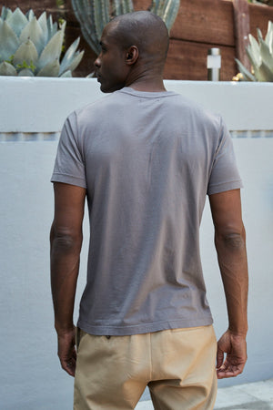 The back of a man wearing a Velvet by Graham & Spencer SAMSEN WHISPER CLASSIC V-NECK TEE and khaki pants.