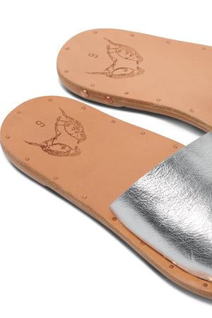 a pair of Mockingbird sandals by Beek on a white surface.