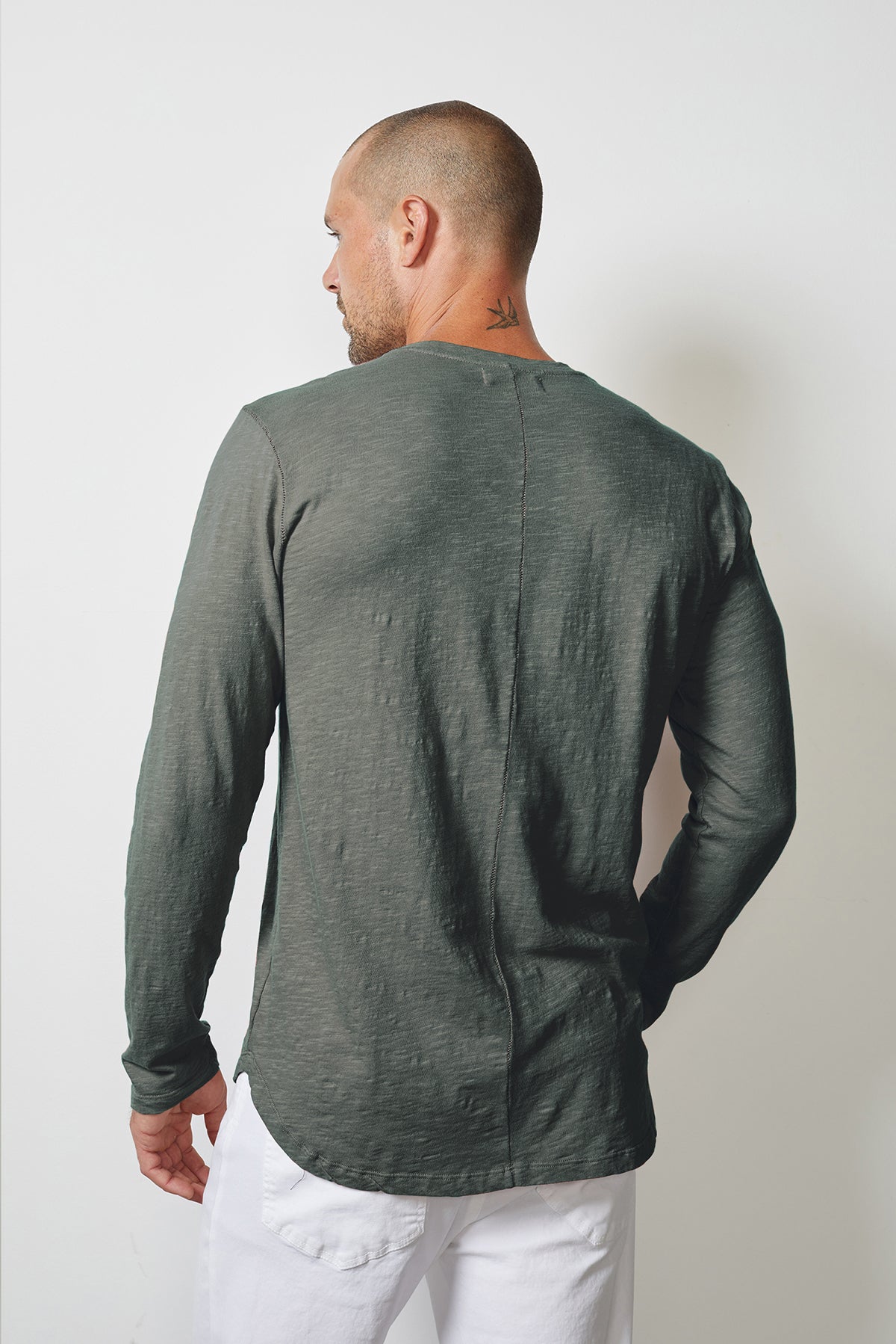 The back view of a man wearing a Velvet by Graham & Spencer CHANCE CREW NECK TEE.-14905793806529