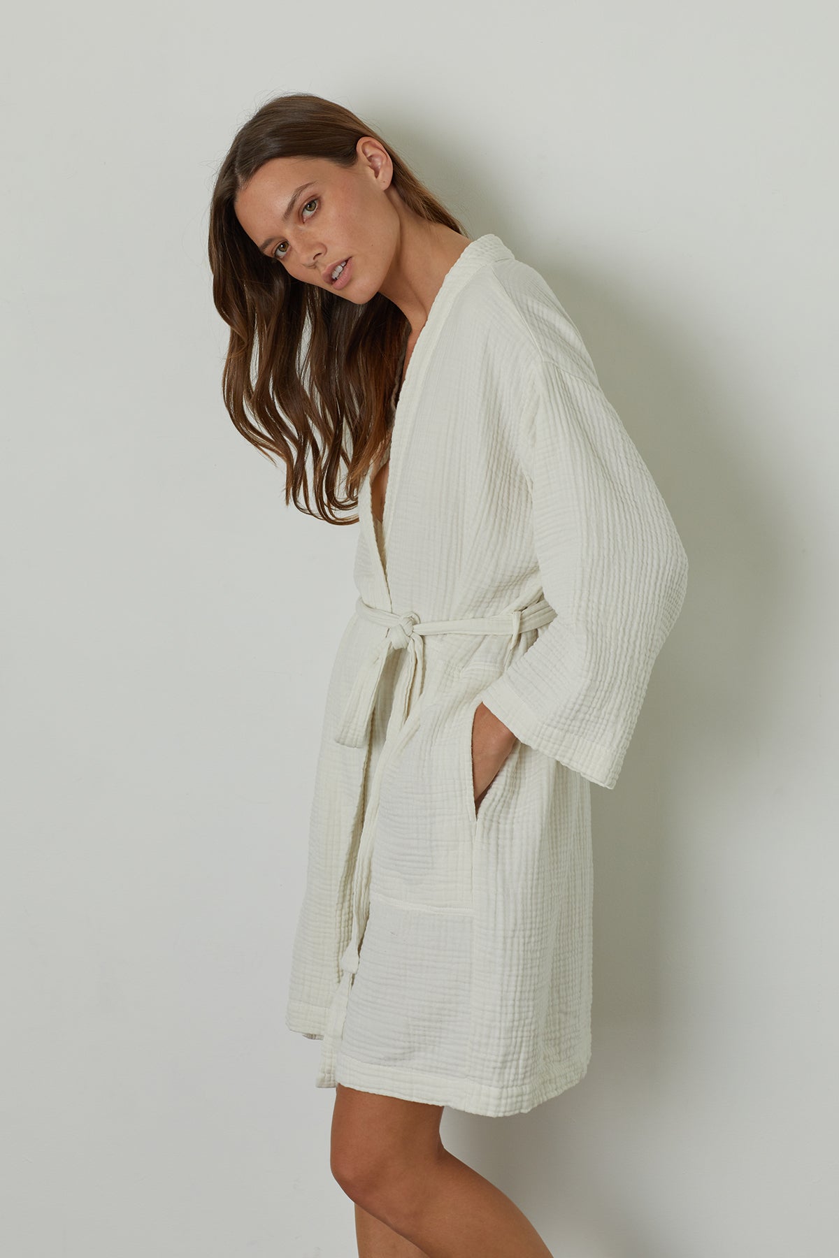   The model is wearing a soft texture, MINI COTTON GAUZE ROBE by Jenny Graham Home with a belt. 