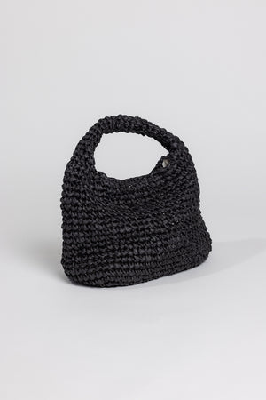 Sentence with replacement: Black crocheted Velvet by Graham & Spencer SLOUCH BAG with a wrist loop, shown against a plain white background.