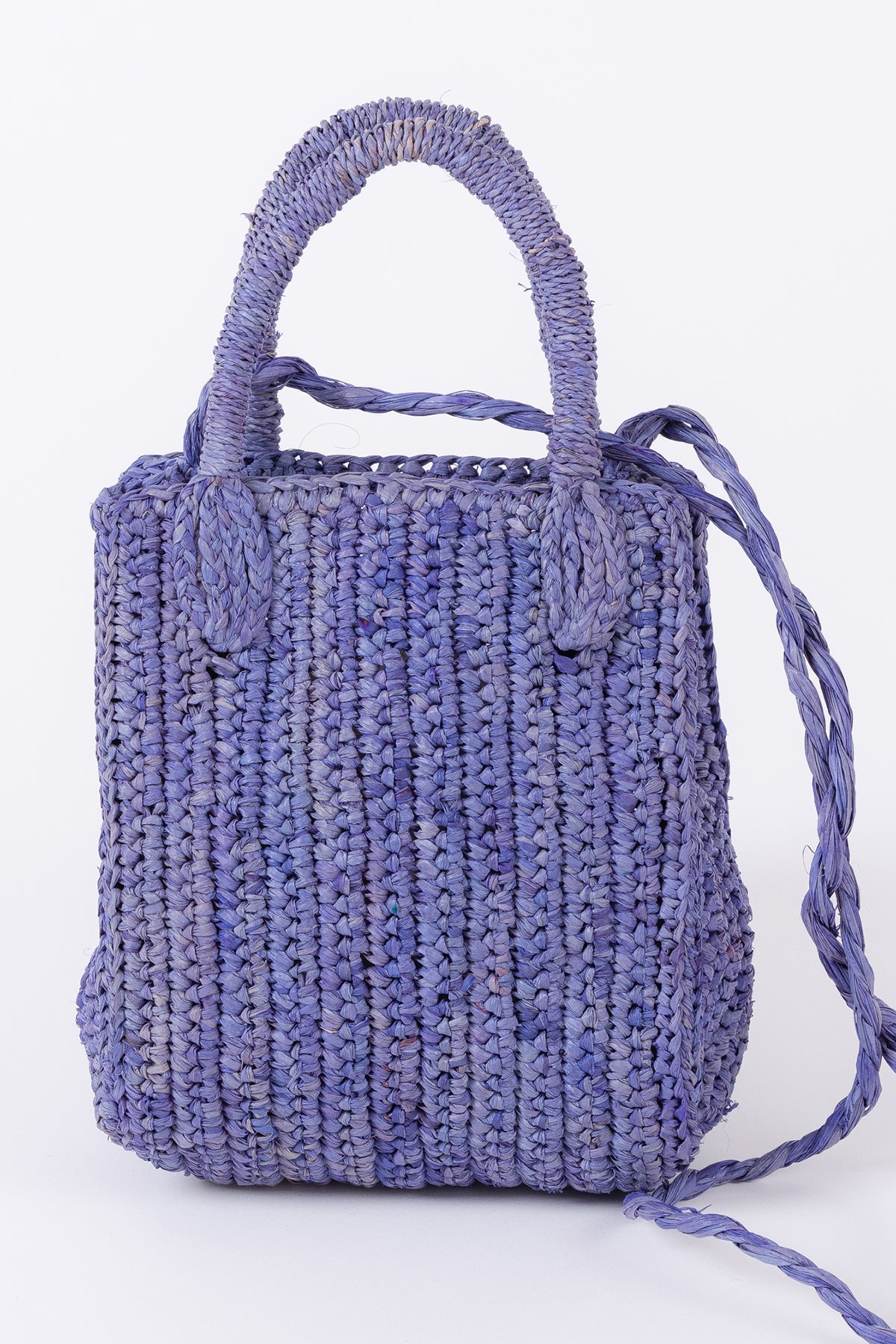 Woven lilac MIMI RAFFIA CROSSBODY tote bag by Velvet by Graham & Spencer against a white background.-26051037397185