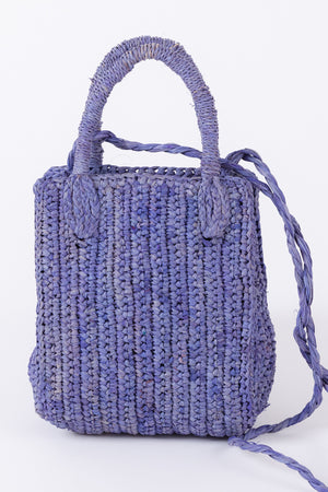 Woven lilac MIMI RAFFIA CROSSBODY tote bag by Velvet by Graham & Spencer against a white background.