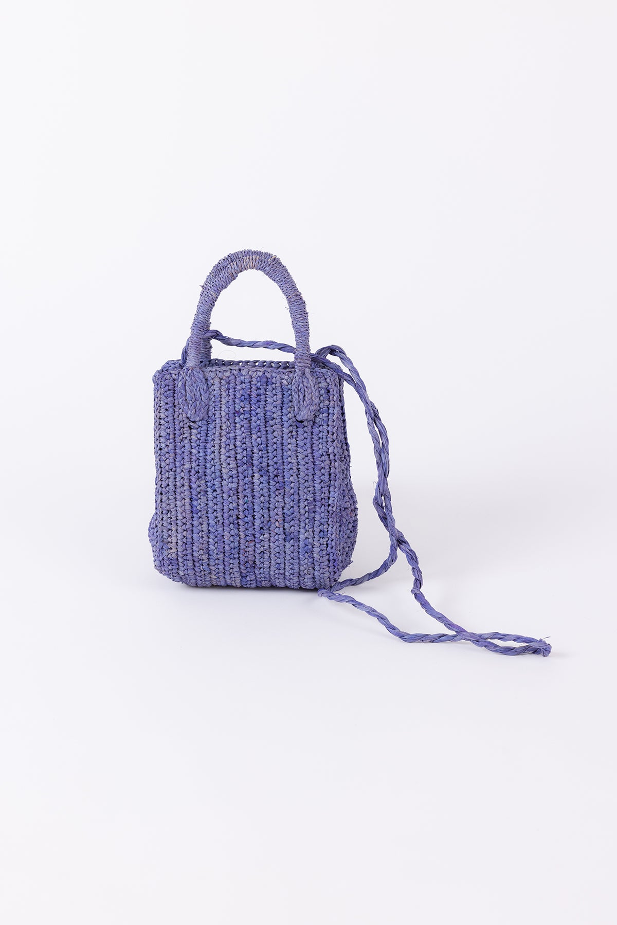   Knitted purple MIMI RAFFIA CROSSBODY bag with a single handle displayed against a white background by Velvet by Graham & Spencer. 