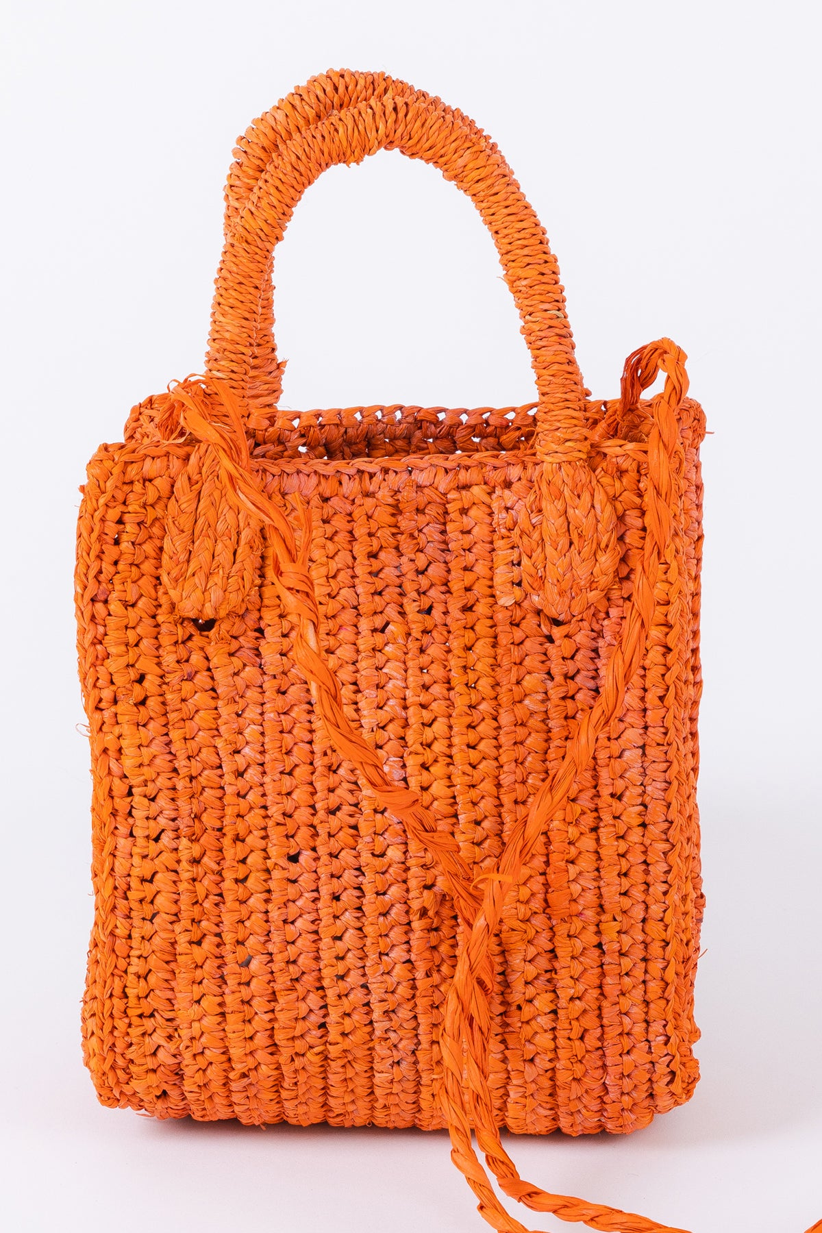 MIMI RAFFIA CROSSBODY handbag with tassel details on a white background, by Velvet by Graham & Spencer.-26051037429953