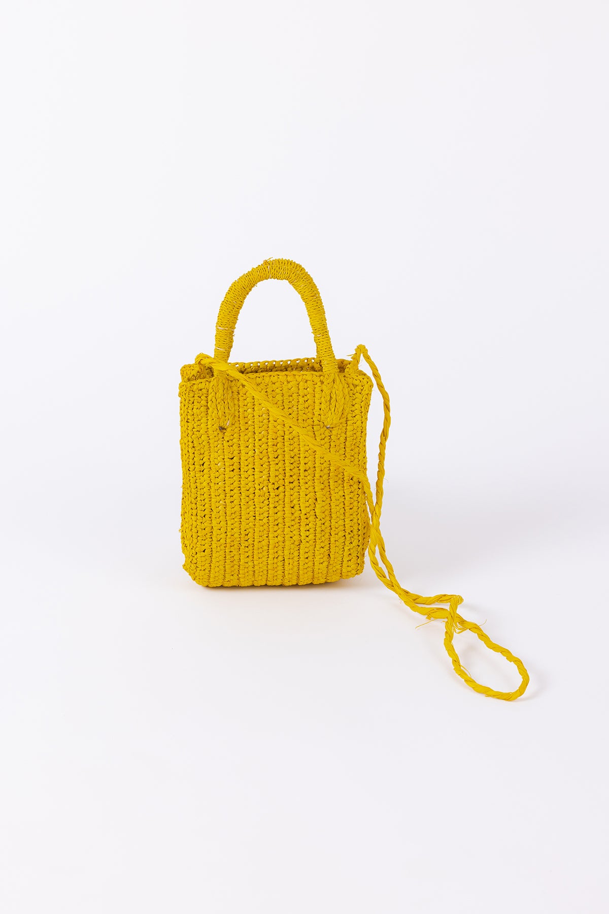 Bright yellow knitted MIMI RAFFIA CROSSBODY bag with a strap on a white background by Velvet by Graham & Spencer.-26047808078017